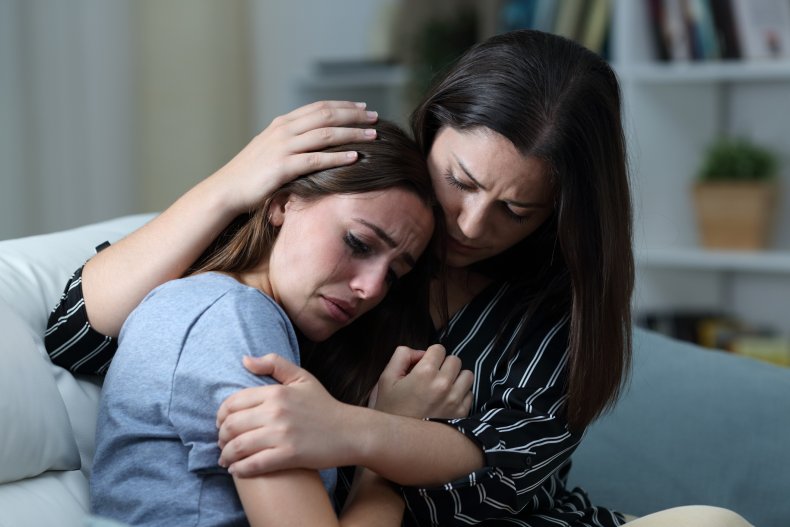 A woman comforting her crying friend