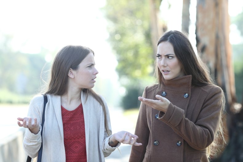 Two women arguing while walking outdoors