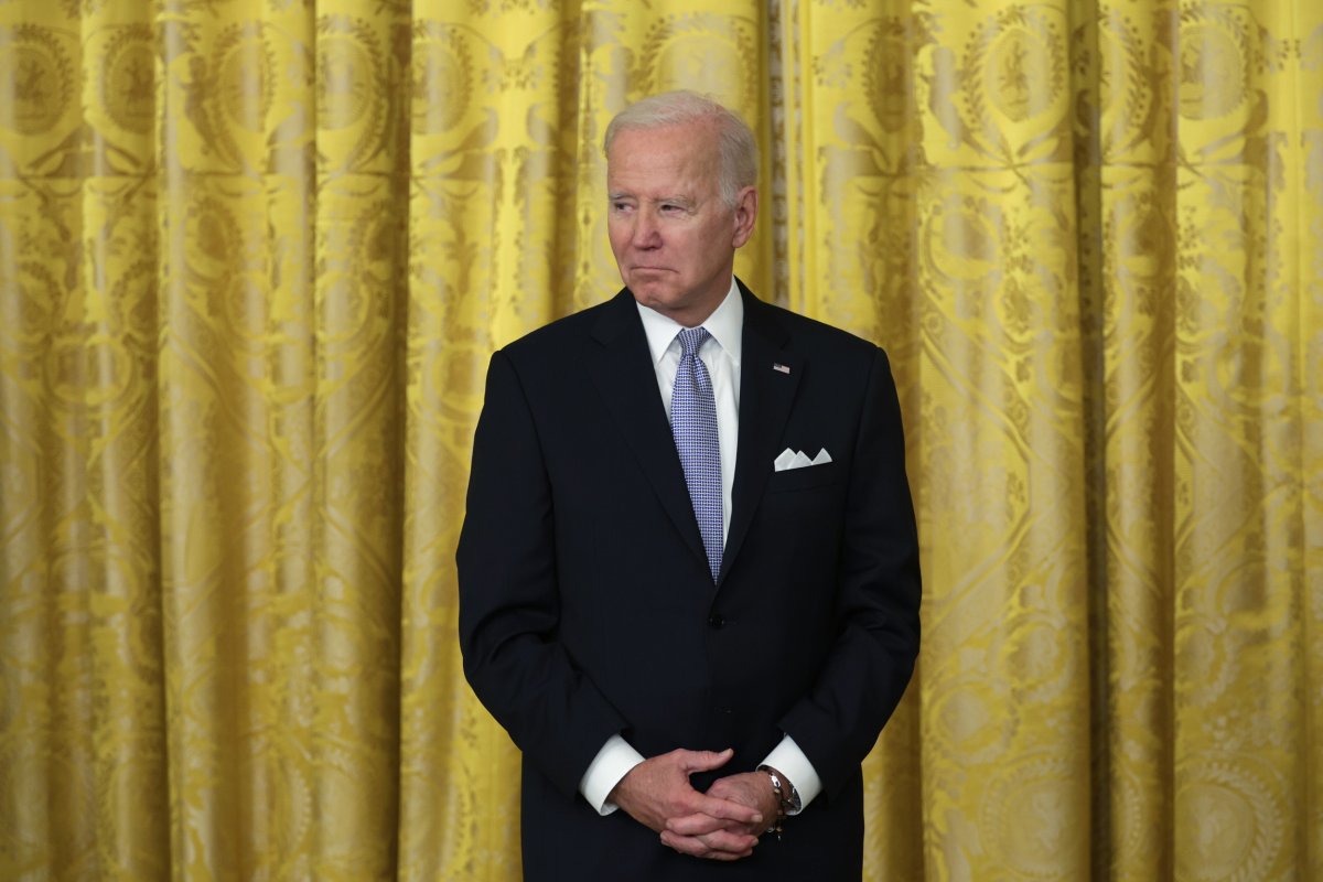 President Joe Biden listens as he hosts