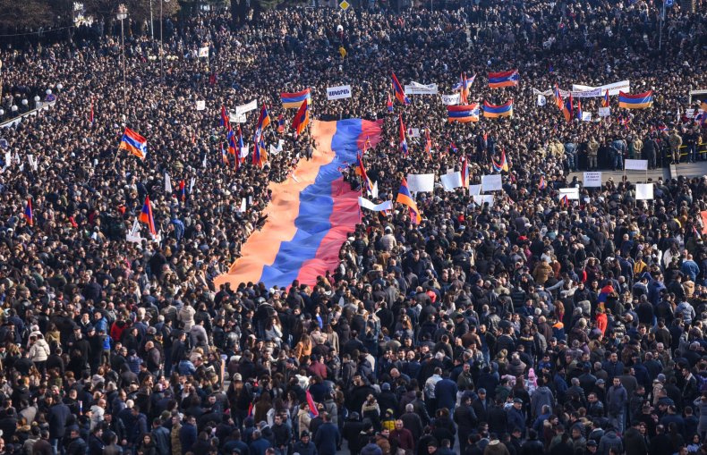 Protesters hold a giant Armenian flag