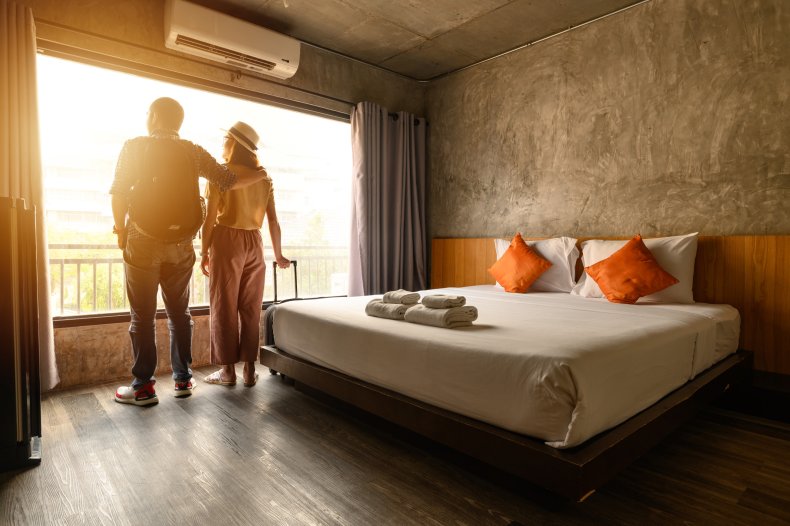 Couple standing in a guest room.