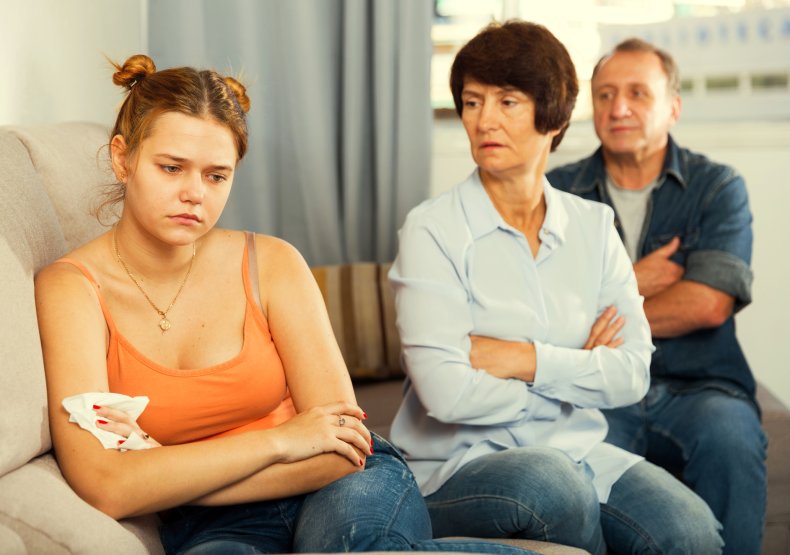 Teenager crying while arguing with parents
