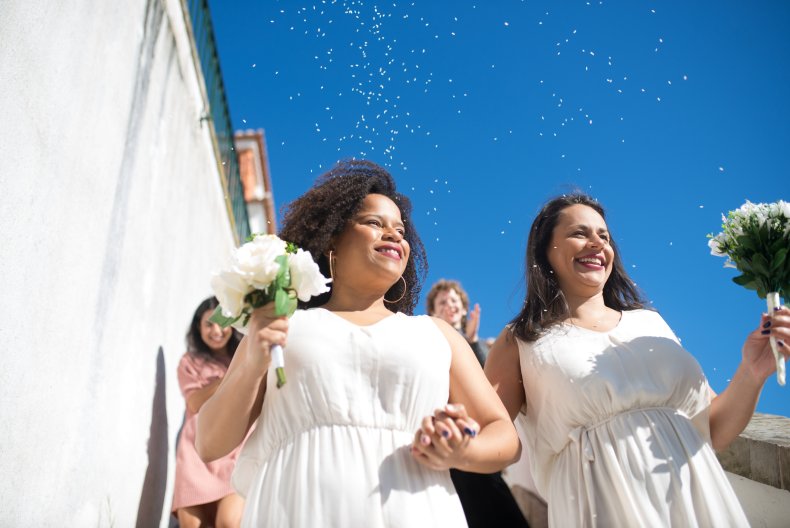 Two brides walking down a staircase