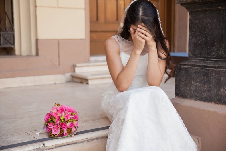 A bride crying on church steps