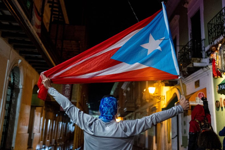 A protester holds a Puerto Rican flag