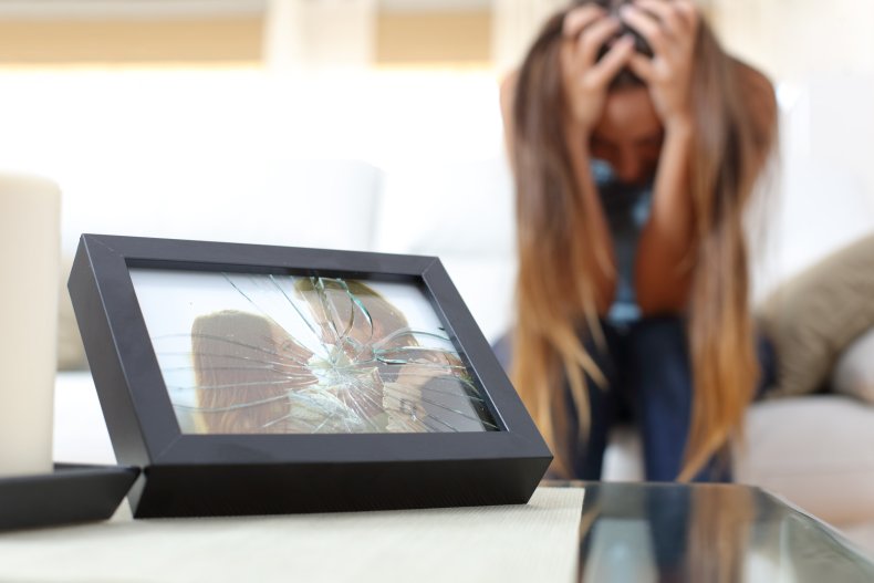 Shattered frame with couple image, woman upset.