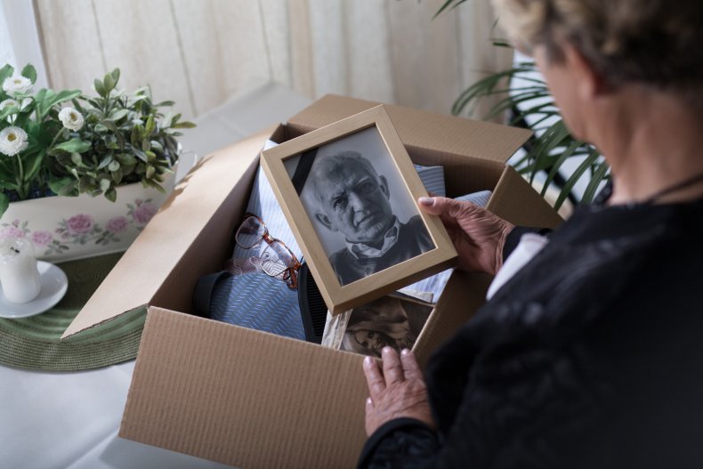 Elderly widow staring at photo of husband