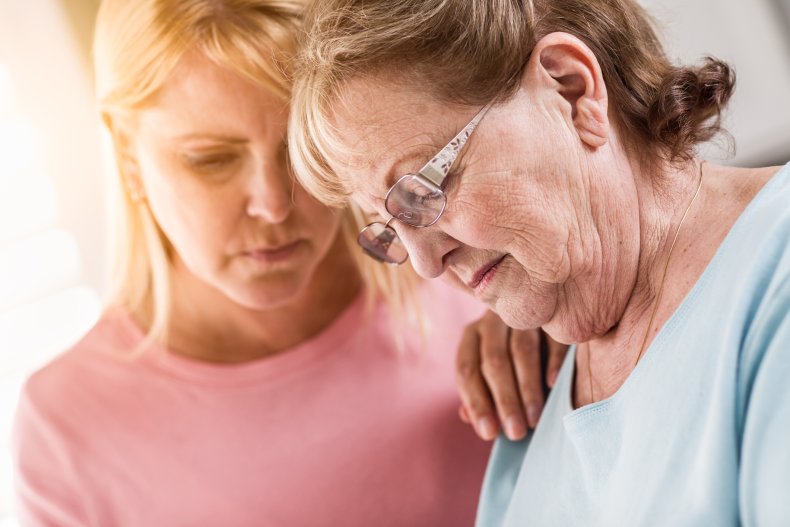 Devastated elderly woman being comforted by daugthter
