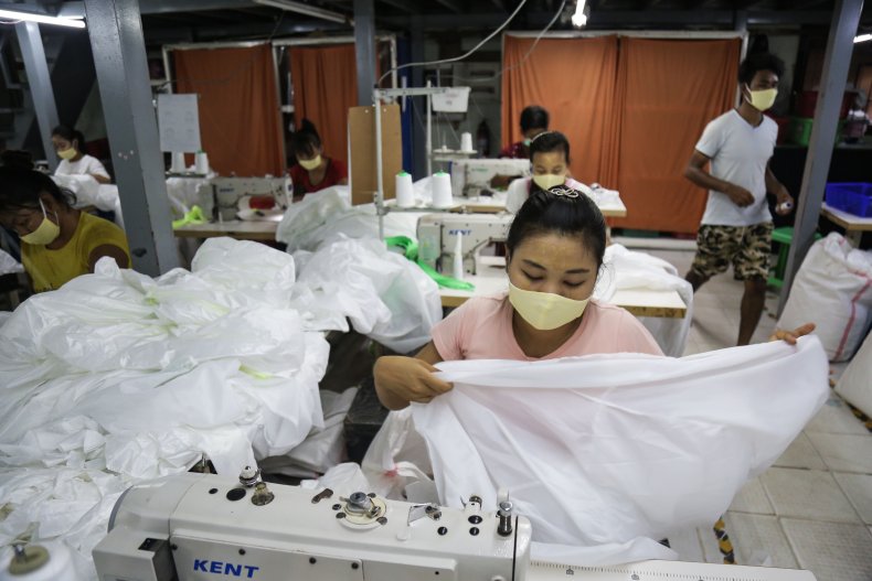 Workers wearing face masks sewing