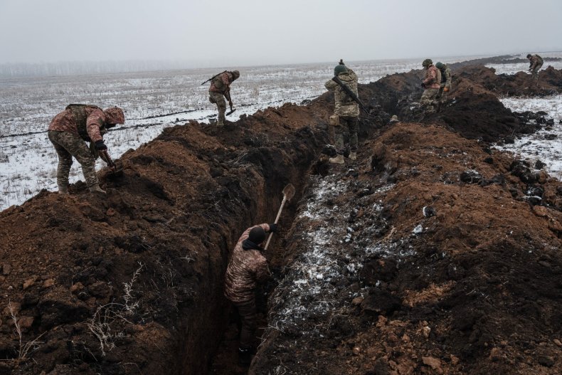 Ukrainian servicemen make a trench near Bakhmut