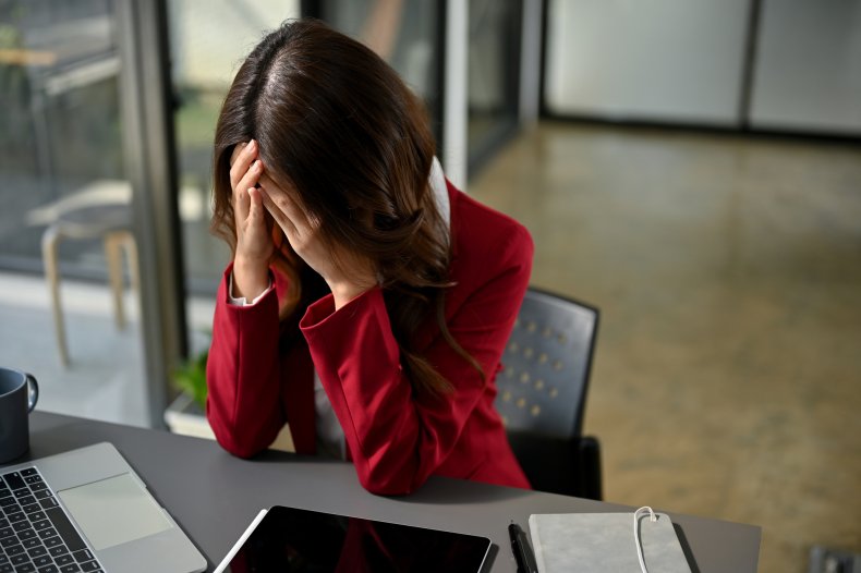 Depressed office worker crying at her desk