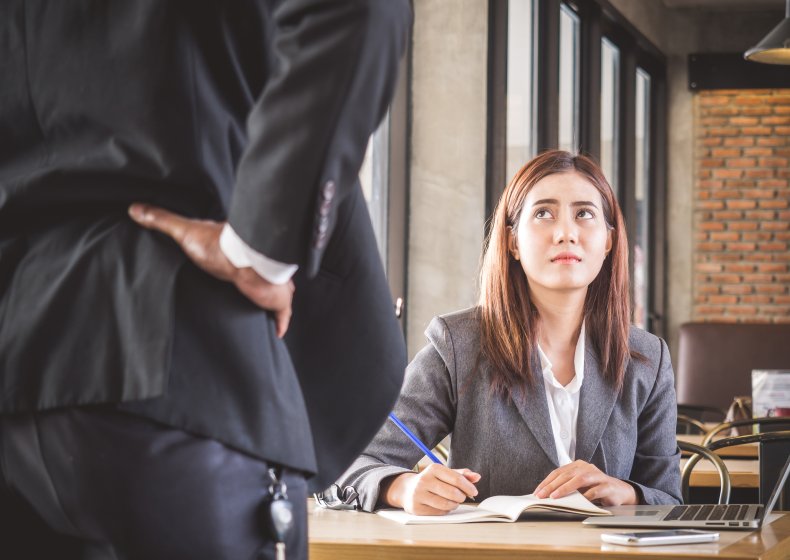 Nervous worker looking up at angry boss