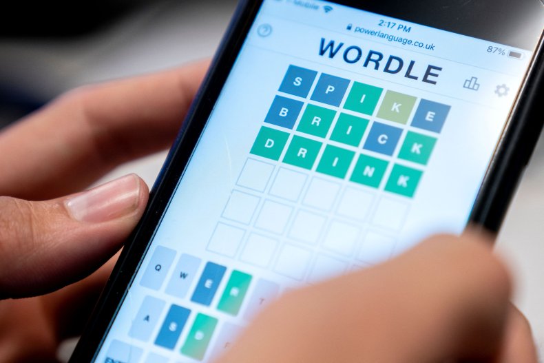 This photo illustration shows person playing Wordle