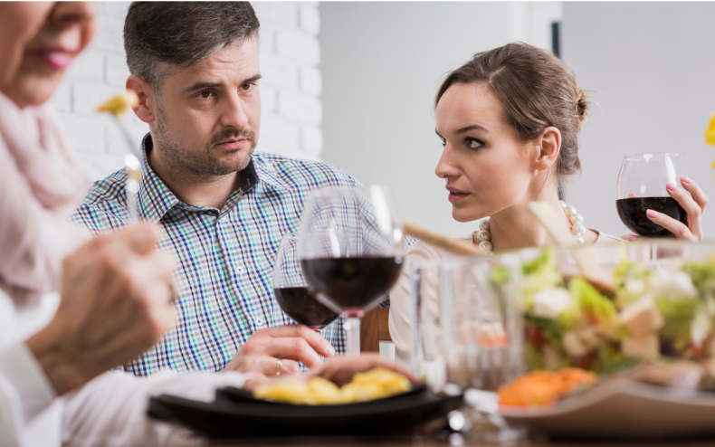 A couple looking unhappy over dinner.