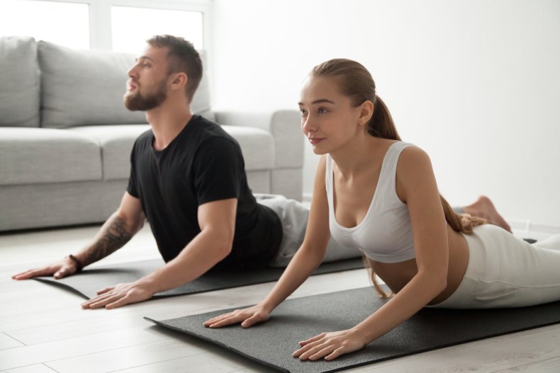 Man and woman doing yoga side-by-side