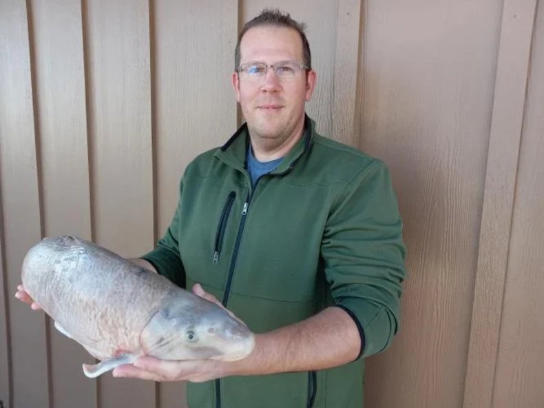Travis Uebinger with his blue sucker fish
