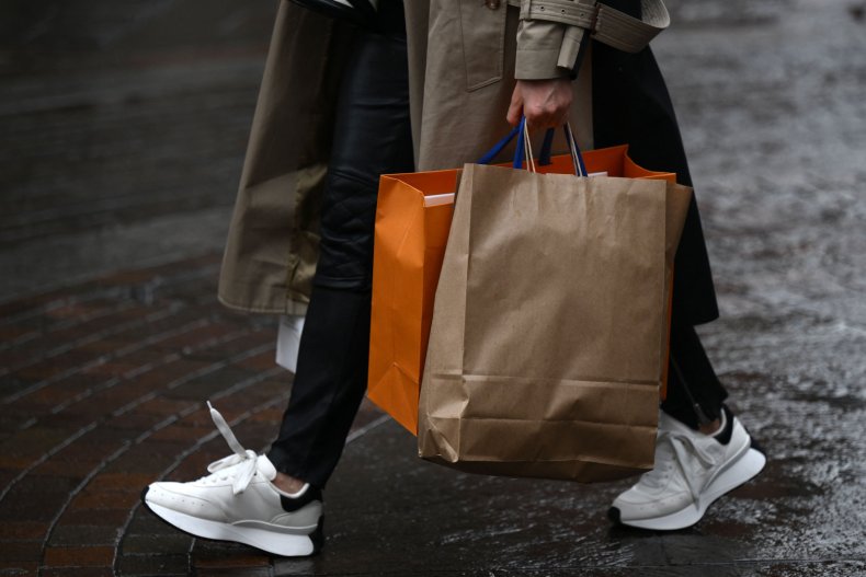 A shopper carrying full shopping bags