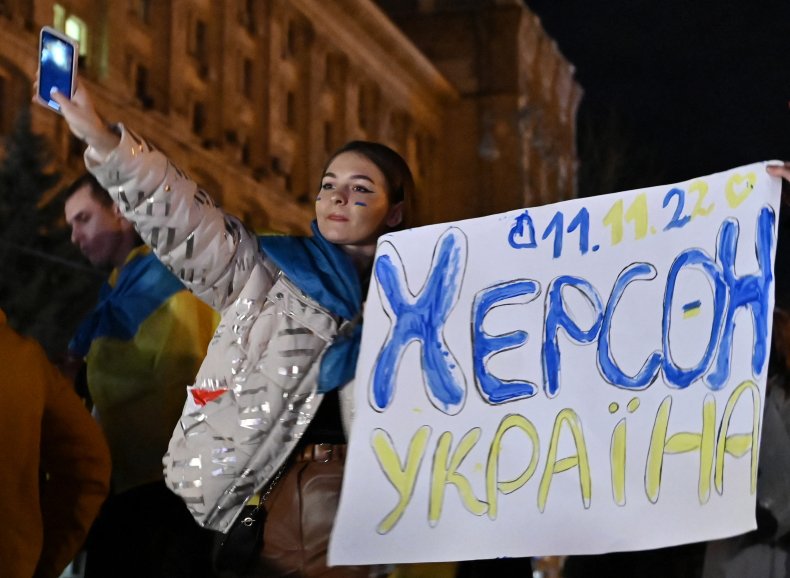 A woman holds a slogan in Kherson