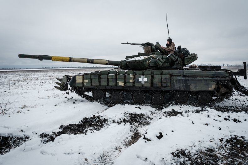 Ukraine soldier rides on tank