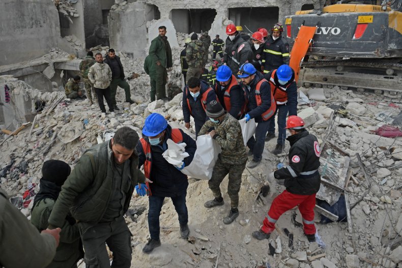 Rescuers carry the body of a victim 