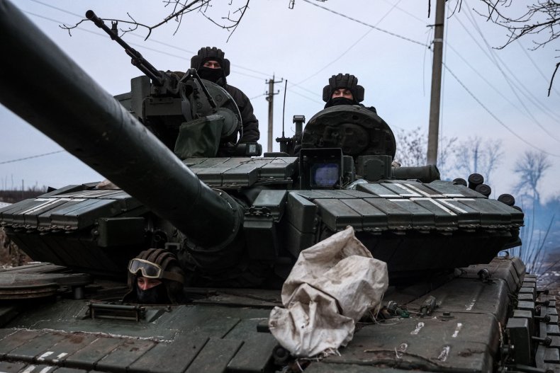 Ukrainian servicemen drive their tank 