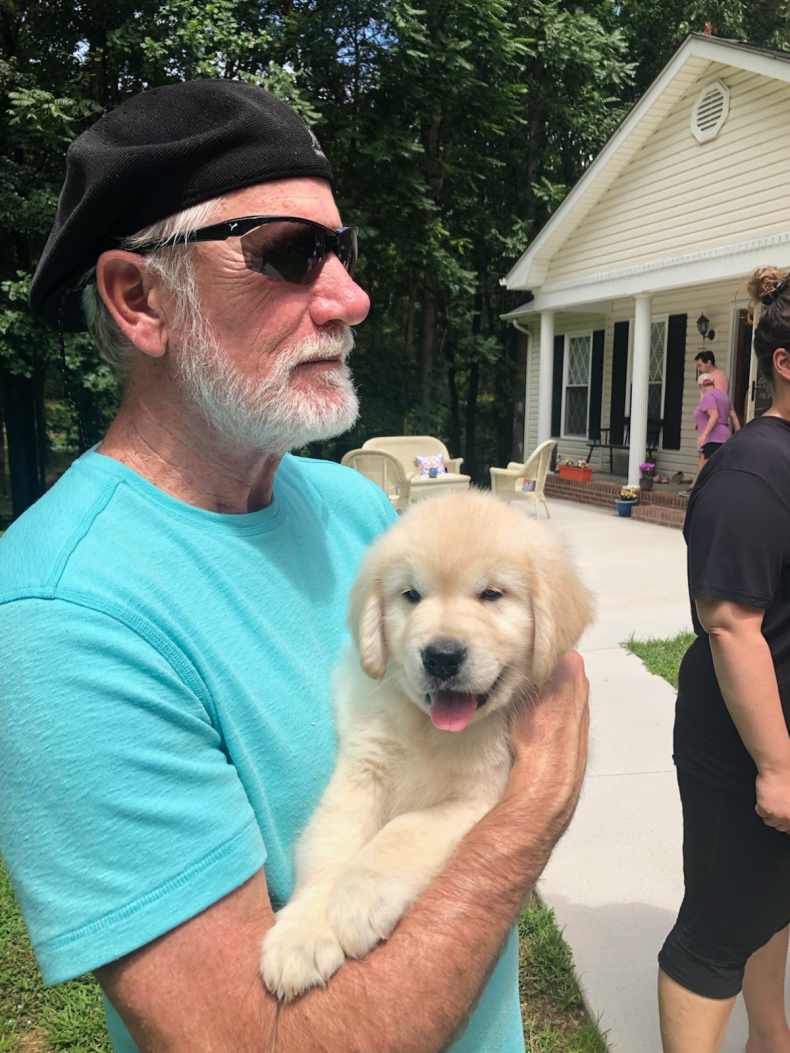 Bryn Evans' father and their puppy Obie.