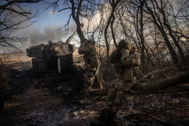Ukrainian soldiers fire at Russian troops