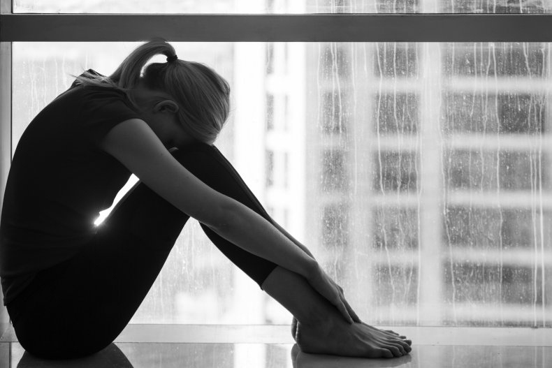 Sad woman at window