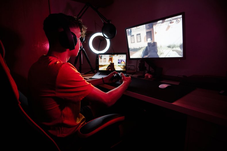 Teenage boy playing computer game in dark