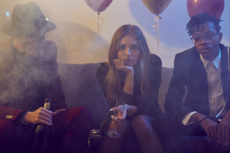 Bored woman on sofa at a party