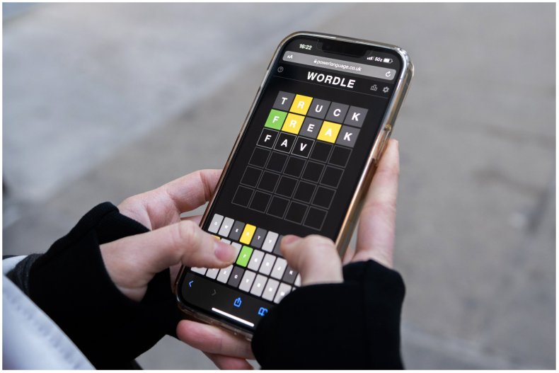 Woman playing Wordle on her phone