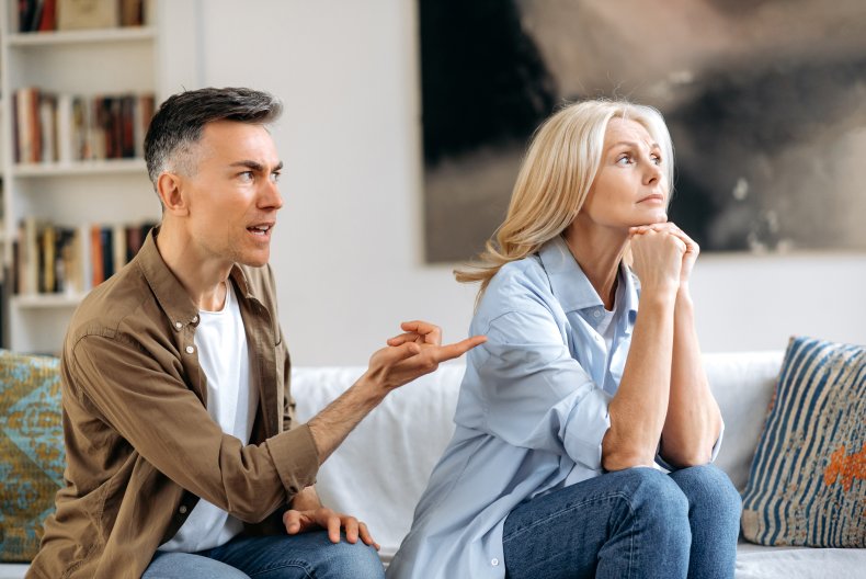 Middle-aged woman ignoring her yelling husband