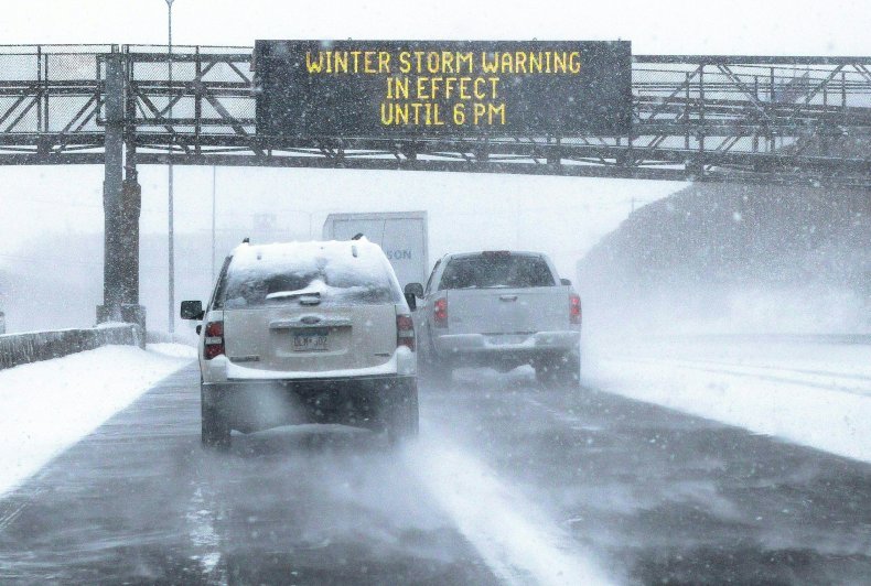 Cars drive on snowy Minnesota highway