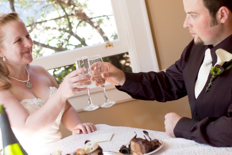 Bride and groom clinking champagne glasses