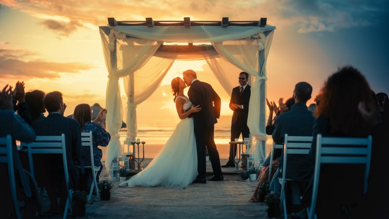 A beach wedding at sunset.