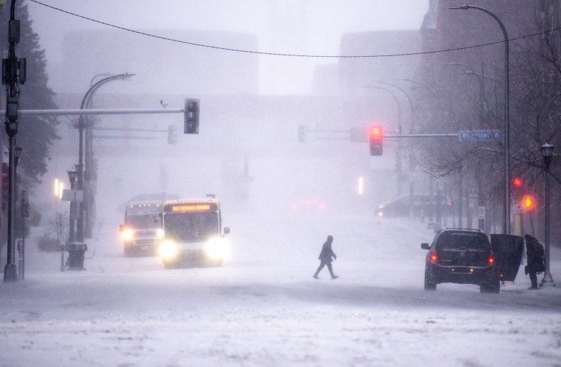 Person walks in snowy street in Minneapolis