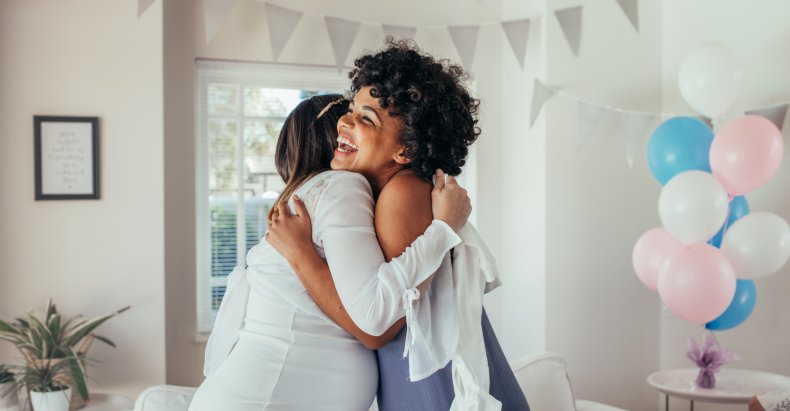 Two women hugging at baby shower. 