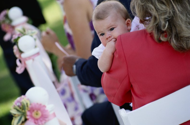 Mother holding her baby during a wedding 