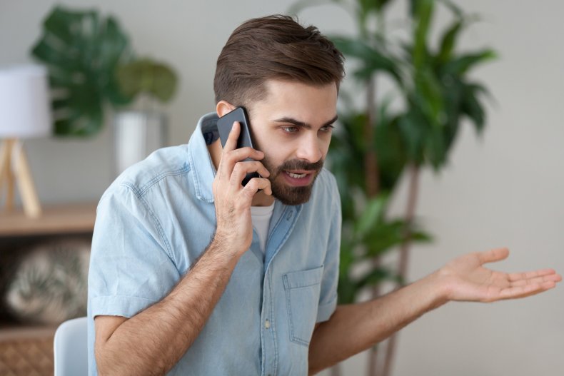 Angry young man on a mobile phone