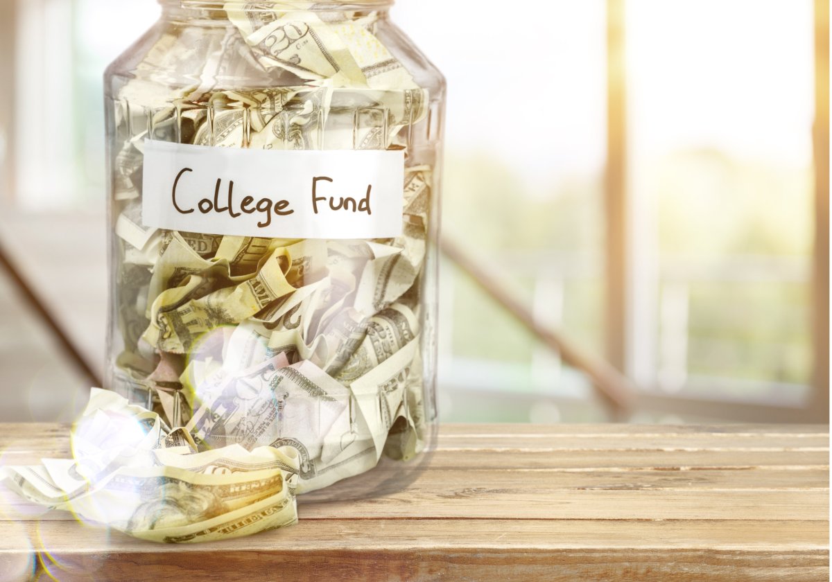 "College fund" jar with U.S. money bills. 