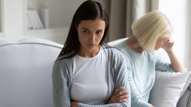 Teenage girl sitting next to older woman.
