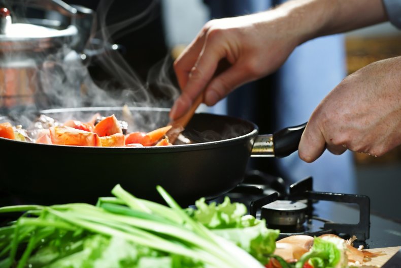 Close-up of man's hands cooking a stirfry