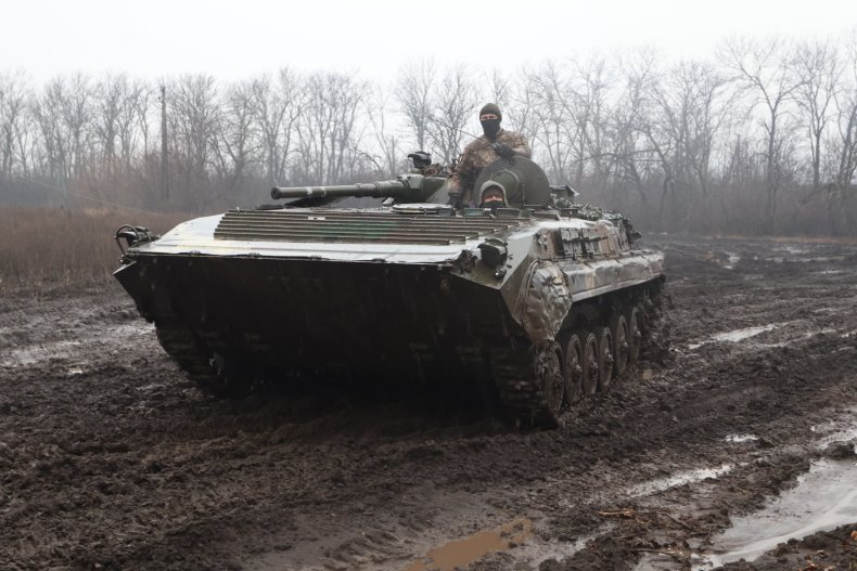 Ukrainian troops drive a tank in Bakhmut
