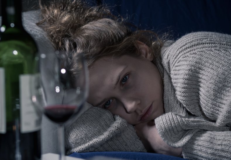 Woman looking distraught with wine.