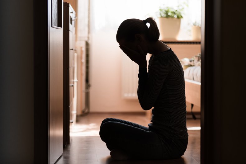 Woman holding head in her hands