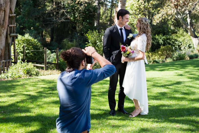 Wedding photographer taking pictures of couple