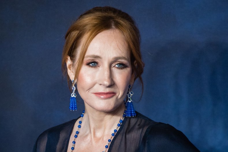 J.K. Rowling posing against blue background