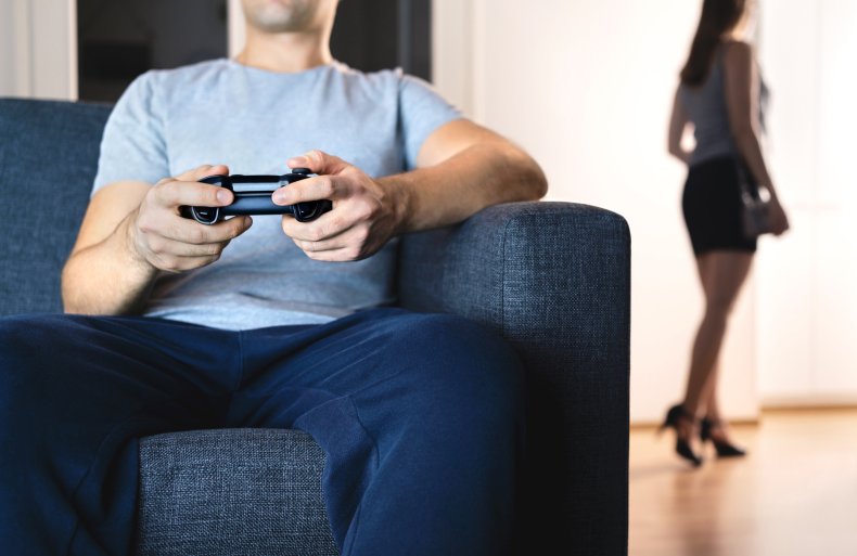 Man playing video games on sofa 
