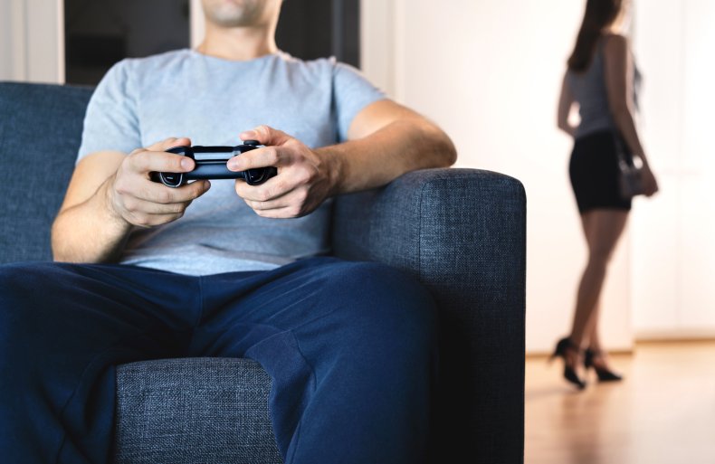 Man playing video games on sofa