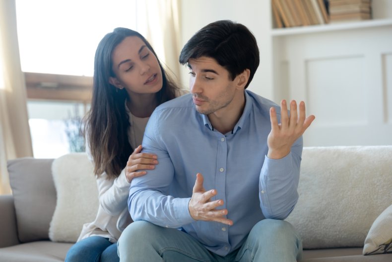 Woman pleadingly touching her frustrated husband's arm